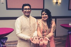 indian bride and groom showing their mehndi art indian bride and groom showing their mehndi art