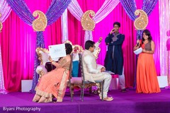 Adorable indian couple playing a game during sangeet pre- wedding celebrations,sangeet,indian bride and groom