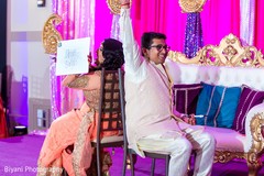 Cheerful indian couple playing a game at their sangeet night pre- wedding celebrations,sangeet,indian bride and groom