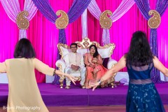 Indian couple looking at sangeet night performance pre- wedding celebrations,sangeet,indian bride and groom