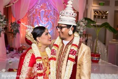 Indian bride and groom looking at each other capture indian wedding ceremony,indian bride fashion,indian groom fashion,bridal jewelry