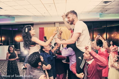 Joyful sangeet party. sangeet,pre-wedding celebrations,dj,indian bride and groom