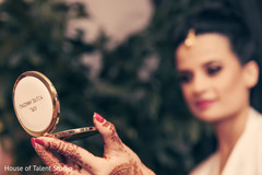 Indian bride takes a look to her makeup. indian bride,getting ready,hair and makeup