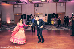 Indian newlyweds traditional dance. indian wedding reception decor,dhol player,indian bride and groom