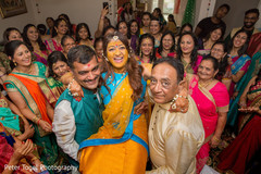 Indian bride being lifted up during haldi ritual pre- wedding celebrations,indian bride,haldi ceremony