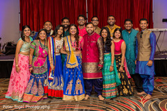 Indian bride and groom posing with guests portrait pre- wedding celebrations,sangeet,indian bride and groom