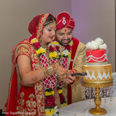 Indian bride and groom's cutting the cake scene indian wedding reception,indian wedding cake,indian wedding cake design,indian bride and groom