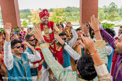 Indian groom being lifted up during baraat indian groom fashion,indian groomsmen,indian wedding baraat