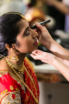 Beautiful indian bride being dolled up for her ceremony indian bride hair and makeup,indian bride getting ready,bridal jewelry