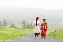 Indian bride and groom walking holding hands outdoor photography,indian groom fashion,indian bride fashion
