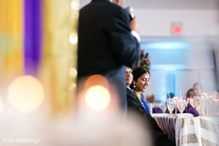 Sweet indian couple listening to wedding speech indian wedding reception,indian wedding reception photography,indian bride and groom