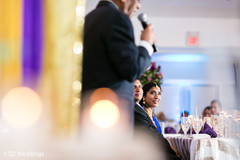Gorgeous indian couple listening to speech indian wedding reception,indian wedding reception photography,indian bride and groom