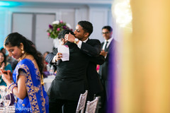 Indian groom being hugged by groomsman indian wedding reception,indian wedding reception photography,indian bride and groom,indian groomsmen