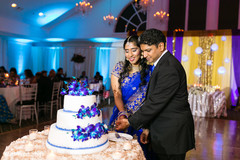 Indian wedding cutting the cake scene indian wedding reception,indian wedding reception photography,indian bride and groom,indian wedding cake