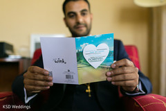 Indian groom reading card from bride Indian groom reading card from bride