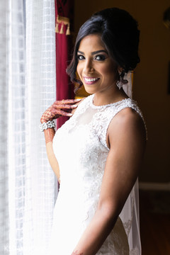 Indian bride glowing in her white wedding attire. Indian bride glowing in her white wedding attire.