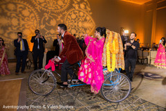 Indian bride and groom Showstopping entrance. indian wedding reception,indian bride and groom,rickshaw