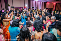 Guests having fun in the dance floor indian wedding reception,indian wedding party,dj
