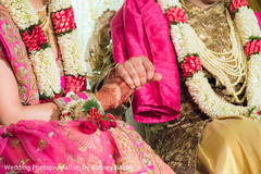 Indian couple holding hands during ceremony Indian couple holding hands during ceremony