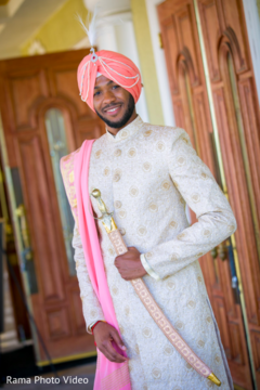 Handsome indian groom in traditional attire indian groom fashion,peach dupatta,golden sherwani