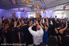 Indian wedding reception guests dancing the night away Indian wedding reception guests dancing the night away