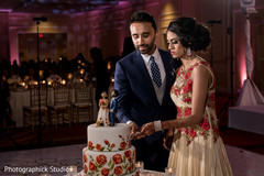 Indian couple cutting their wedding cake indian wedding cake,tier cake