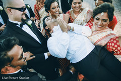 Bridal party carrying the groom indian groom,indian bridesmaids,suit