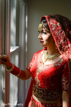 Glamorous india bride looking out the window Glamorous india bride looking out the window