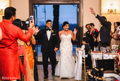 Indian couple making their grand entrance indian wedding reception,indian bridal fashion,indian couple