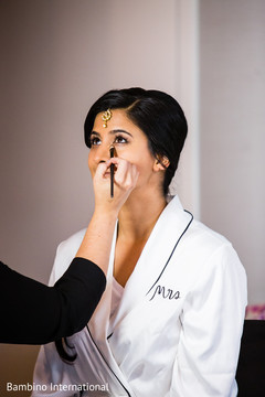 Lovely bride getting her makeup done indian bride getting ready,indian bride hair and makeup,indian bride
