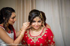 Indian bride getting help with jewelry indian bride getting ready,indian bride hair and makeup,indian bride,bridal jewelry