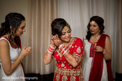 Sweet indian bride putting jewelry on indian bride getting ready,indian bride hair and makeup,indian bride,bridal jewelry