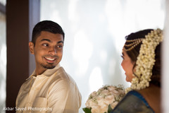 Gorgeous indian couple looking at each other indian bride and groom,indian bridal bouquet,first look photography