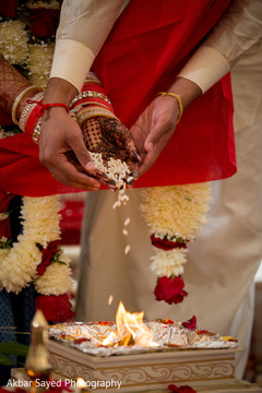 Sweet indian couple making offerings to sacred fire indian wedding ceremony,indian wedding ceremony photography,indian bride and groom