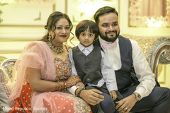 Charming indian couple posing with indian boy for photo shoot indian wedding reception,indian wedding reception photography,indian bride and groom