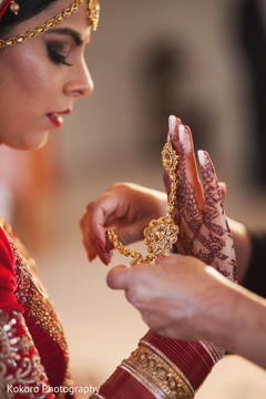 Lovely indian bride putting jewelry on Lovely indian bride putting jewelry on