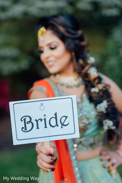 Adorable indian bride holding bride sign Adorable indian bride holding bride sign