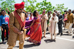 Indian groom escorted by friends and family. Indian groom escorted by friends and family.