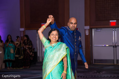 Indian groom dancing with his mother Indian groom dancing with his mother