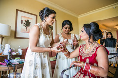Indian bridesmaids helping bride to get ready Indian bridesmaids helping bride to get ready