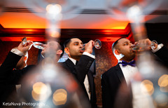 Indian groom and groomsmen celebrating with a glass of champagne Indian groom and groomsmen celebrating with a glass of champagne