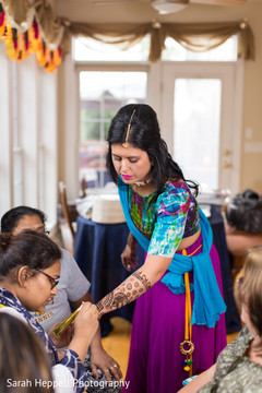Indian bride getting mehndi art done Indian bride getting mehndi art done