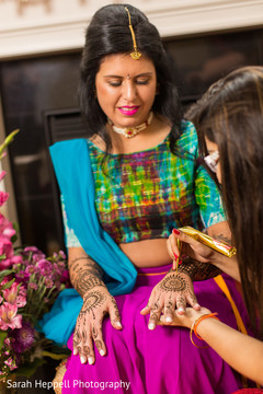 Henna artist making mehndi art Henna artist making mehndi art