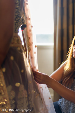 Final touch ups to the bridal outfit. Final touch ups to the bridal outfit.