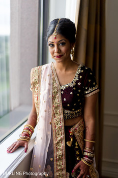 Indian bride glowing in wine and gold bridal lehenga. Indian bride glowing in wine and gold bridal lehenga.