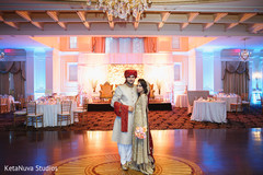 Indian couple at their wedding venue. pakistani bride,indian wedding photography,bridal bouquet