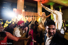 Indian couple being lifted up during sangeet Indian couple being lifted up during sangeet