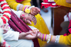 Indian bride and groom holding hands close up Indian bride and groom holding hands close up
