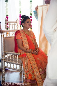 Sweet Indian bride in orange ceremony lehenga. Sweet Indian bride in orange ceremony lehenga.