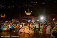 Indian wedding sangeet guests enjoying performances Indian wedding sangeet guests enjoying performances